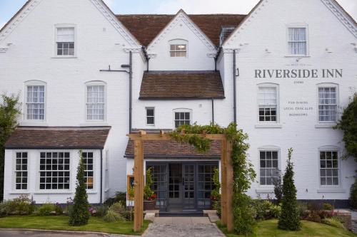 a white house with a sign that reads riverside inn at Riverside Inn by Chef & Brewer Collection in Shrewsbury
