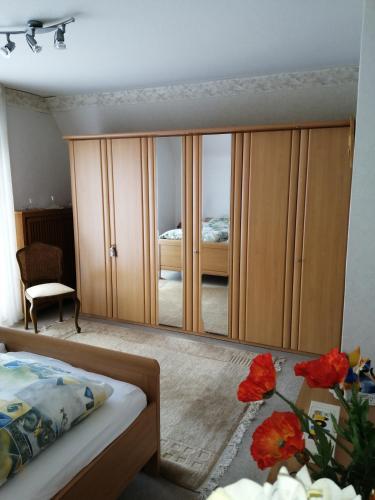 a bedroom with a large mirror next to a bed at Karolinenhof in Schüttorf