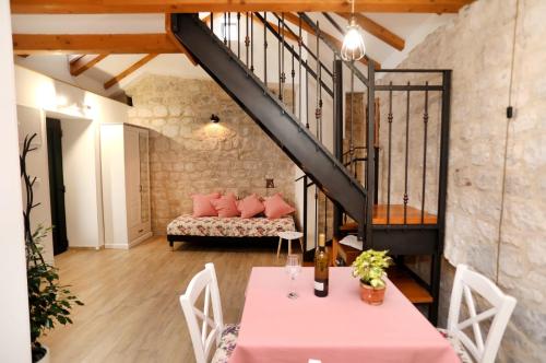 a living room with a couch and a table at Studio apartman Mihaella in Kaštela