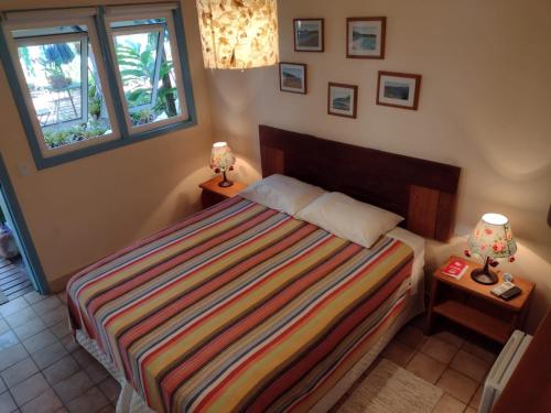 a bedroom with a bed and a window at Pousada Ana Doce in São Sebastião