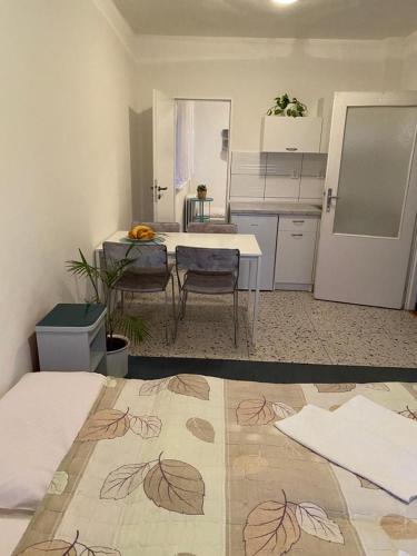 a room with a kitchen with a table and chairs at Apartmán s terasou in Senec