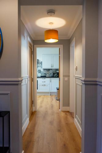 an empty hallway with a kitchen in a house at Airds Apartments in Oban