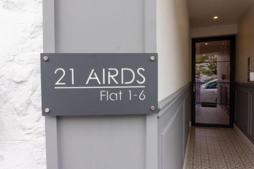 a sign on the side of a building at Airds Apartments in Oban