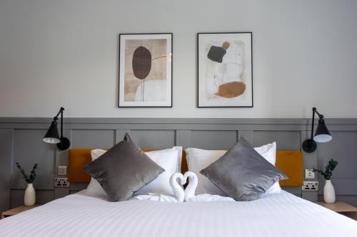 a bedroom with a white bed with two hearts at Airds Apartments in Oban