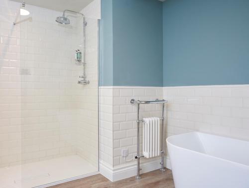 a bathroom with a shower and a tub and a sink at Riverside Inn by Chef & Brewer Collection in Shrewsbury