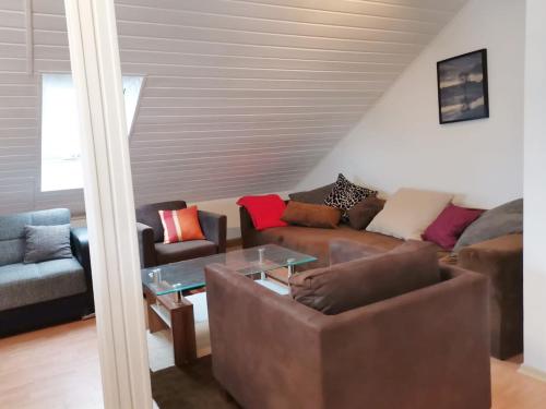 a living room with a couch and a table at FeWo Royal & Goodness Home in Mühlhausen