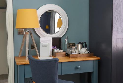 a desk with a lamp and a mirror at Riverside Inn by Chef & Brewer Collection in Shrewsbury