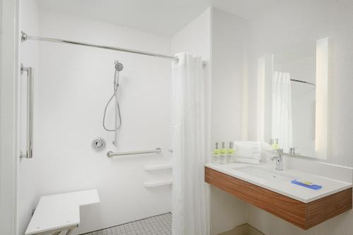 a white bathroom with a sink and a shower at Holiday Inn Express - Tullahoma by IHG in Tullahoma