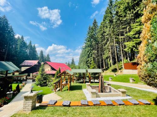 a park with a playground and a picnic shelter at Boutique Hotel Casa Emil in Poiana Brasov