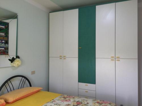 a bedroom with white cabinets and a bed at B&B Mirella in Citta' Sant'Angelo