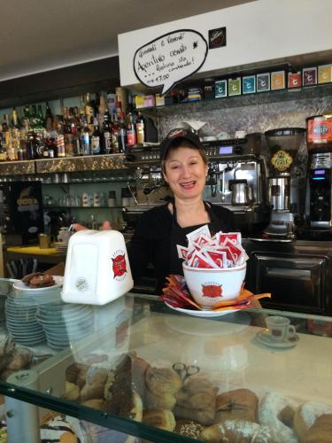 a woman behind the counter of a bakery at B&B Mirella in Citta' Sant'Angelo