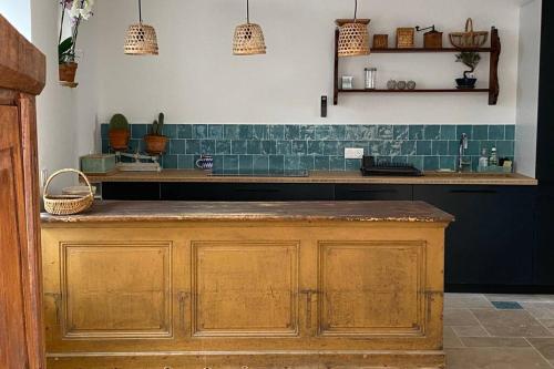 cocina con encimera de madera y azulejos verdes en La Maison de la Tribu - Ile de Ré - La Flotte en La Flotte