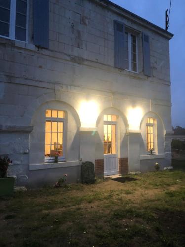 a white house with lights on the side of it at Charmant gite en rez-de-jardin in Saint-Aignan
