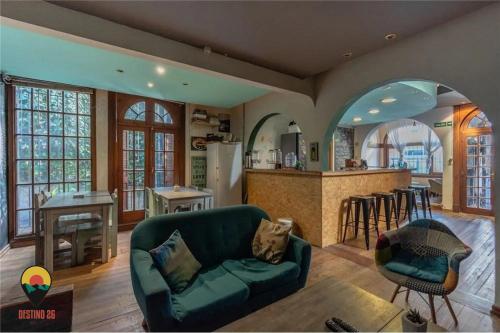 a living room with a couch and a kitchen at Destino26 Hostel in Montevideo