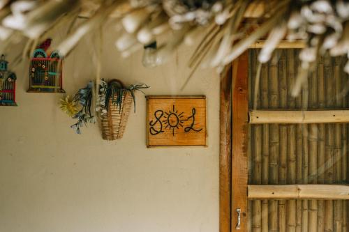 a wooden sign on a wall next to a shelf at Cabañas Mannan in Tanchachín