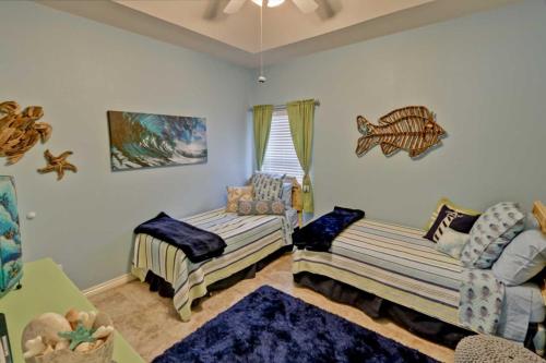 a living room with two beds and a couch at SEA DREAMS 3 condo in South Padre Island