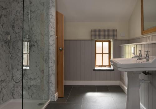 a bathroom with a sink and a shower at Tyddyn at Hendre Rhys Gethin in Betws-y-coed
