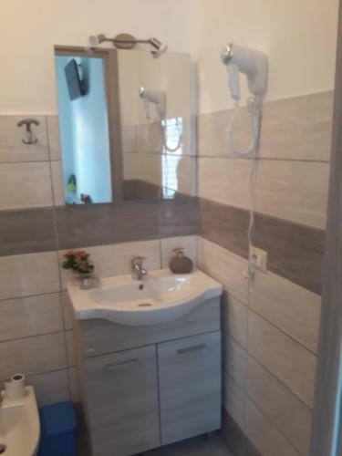 a bathroom with a sink and a mirror at Holiday House Marlin in Giardini Naxos