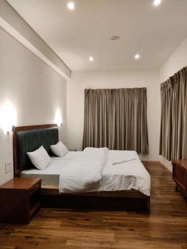 a bedroom with a large bed and a window at Rock Castle Residency in Leh