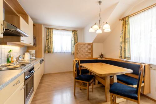 a kitchen with a table and a dining room at Pernerhof in Aich