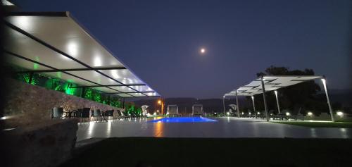 a lit up building with a pool at night at Nina Apartment in Chania Town