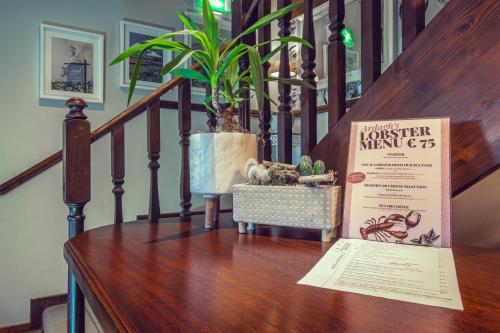 a plant sitting on top of a wooden table at Ardagh Hotel & Restaurant in Clifden