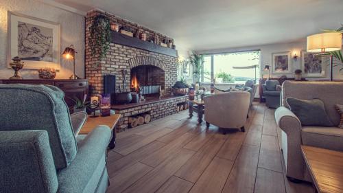 a living room with chairs and a fireplace at Ardagh Hotel & Restaurant in Clifden