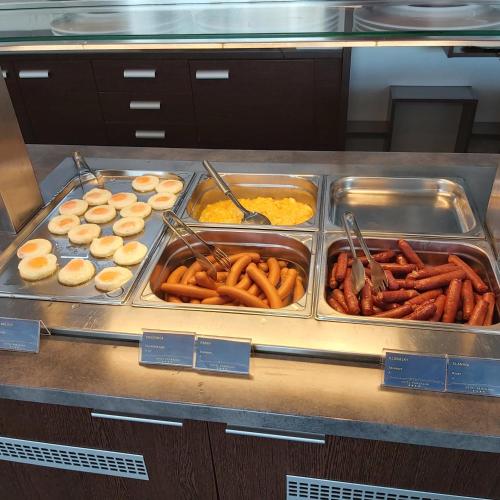 a buffet filled with different types of food in trays at Apartmany Panorama 10X-90X in Štrbské Pleso