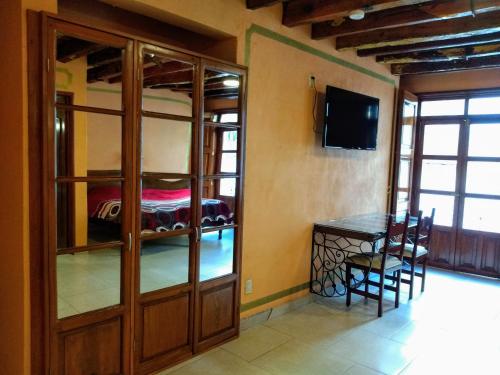 a room with a dining table and a bunk bed at Cuartel 1914 - Hotel Boutique in Zacatecas