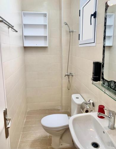 a bathroom with a toilet and a sink at Well being point in Agadir