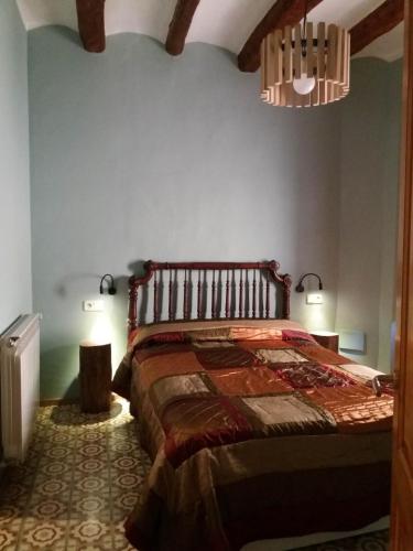 a bedroom with a large bed in a room at Apartaments Falset in Falset