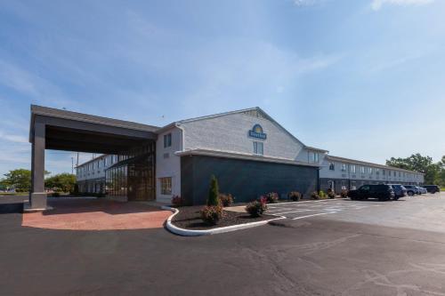 a large building with a parking lot in front of it at Days Inn by Wyndham Sandusky Cedar Point in Sandusky