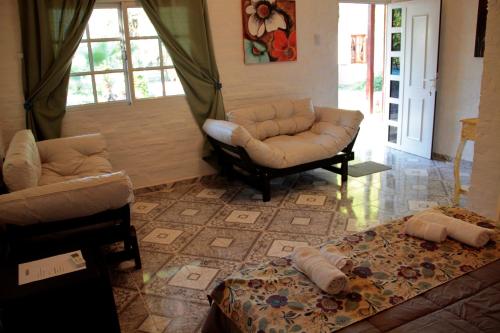 a living room with a couch and a chair at Hotel de Campo El Rebenque in Aviá Terai