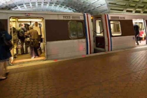 a subway train with people standing inside of it at Urban Retreat Basement Studio Only Two Blocks From Metro! OFF STREET PARKING! in Washington