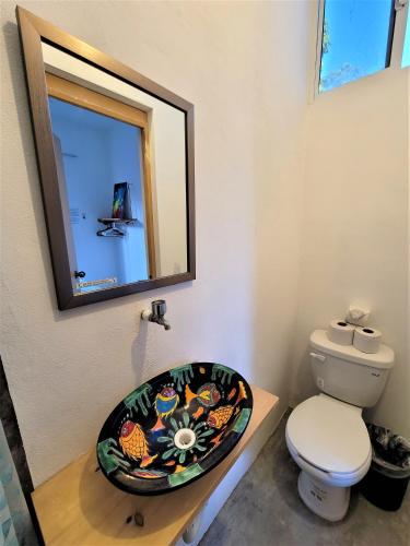 a bathroom with a toilet and a sink at La Ventana Hostel in La Ventana