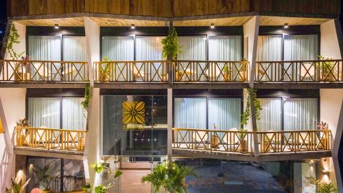 a building with balconies and a butterfly on the wall at Ximena Hotel Boutique in Sayulita