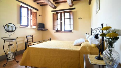 a bedroom with a bed with a teddy bear on it at Le Terre Di Giano in Paciano