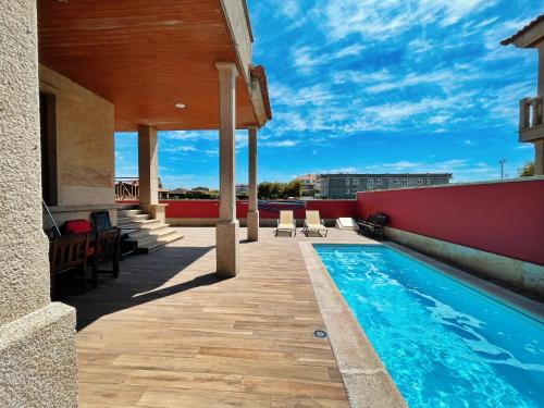 a swimming pool on the roof of a house at CHALET A LANZADA in Sanxenxo