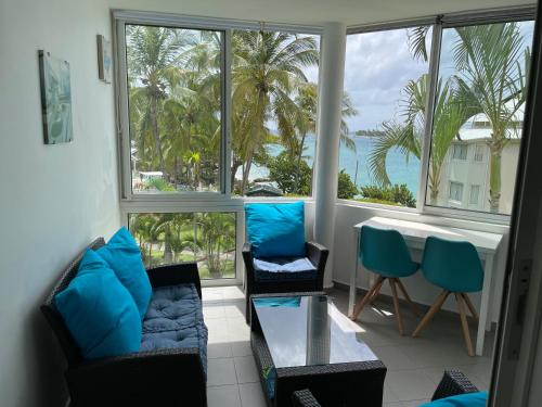 a living room with a view of the ocean at Résidence de la Vieille Tour in Le Gosier