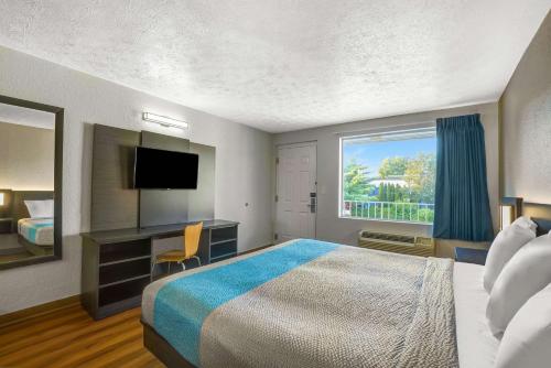 a hotel room with a bed and a desk and a window at Motel 6-Lexington, KY - East I-75 in Lexington
