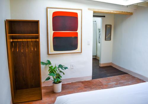 a room with a bed and a painting on the wall at The Parador in Santa Fe