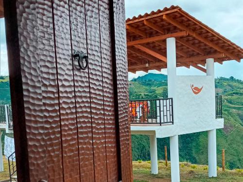 a building with a large metal wall and a balcony at Hotel Kasama in San Agustín