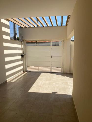 a garage with two garage doors in a building at Casa em Brotas, Refúgio e Aconchego in Brotas