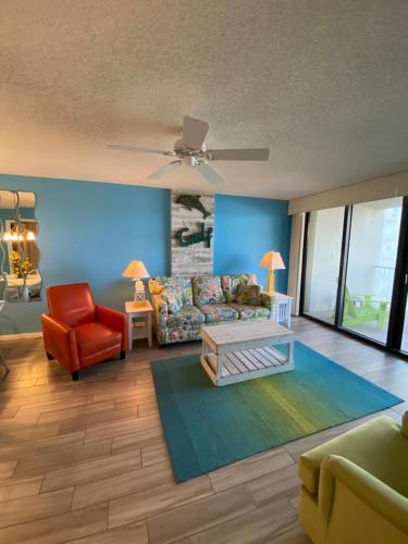 a living room with a couch and a chair at Updated Condo. Great for families. Seaside Beach and Racquet Club 5717 in Orange Beach
