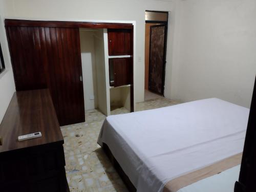a bedroom with a bed and a wooden dresser at Ashly Boulevard in Acapulco