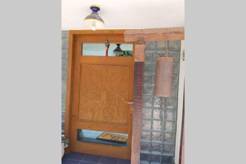 a hallway with a wooden door and a window at CASA DE PLAYA EN ENSENADA in Ensenada