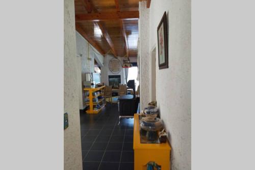 an office with a yellow table and a room at CASA DE PLAYA EN ENSENADA in Ensenada