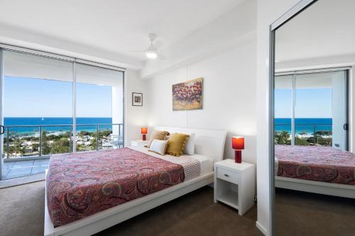 a bedroom with two beds and a view of the ocean at Silver Sea on Sixth Resort in Maroochydore