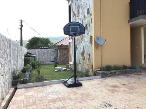 a fan sitting on the side of a house at Hidden Gem In Oyibi New 2 Luxury Bedroom Apartment in Aburi