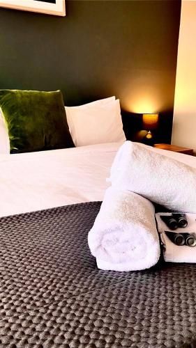 a bedroom with a bed with a white blanket at Pedder Wilderness Lodge in Strathgordon
